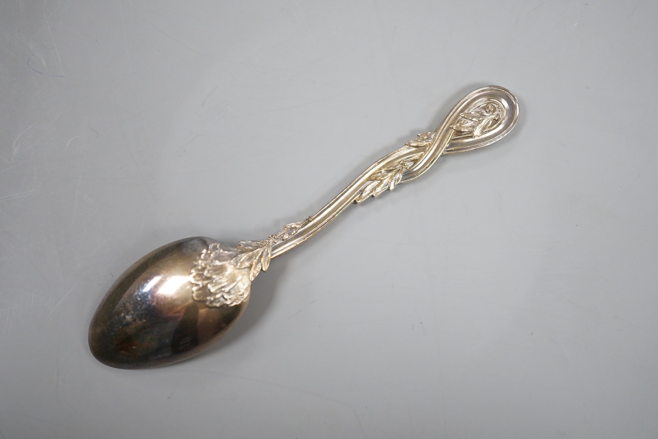 A cased set of twelve early 20th century French 950 standard white metal teaspoons, with foliate scroll terminals, by H. Freres & Co, 99mm.